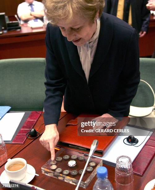 New Polish Finance Minister Zytra Gilowska looks 27 March 2007 at a new euro coin collector issued to celebrate the 50th anniversary of the Treaty of...