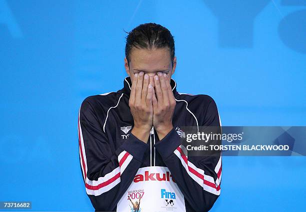 Silver medalist Laure Manaudou of France is seen on the podium after the women's 100m backstroke final 27 March 2007 in Melbourne at the 12th FINA...