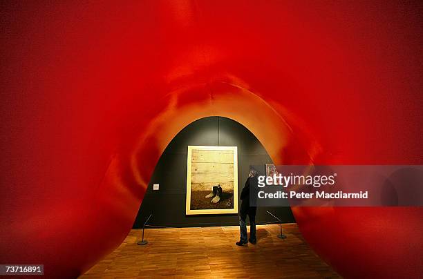 Visitor looks at The Red Model III by Rene Magritte in the Surreal Things Exhibition at the V&A Museum on March 27, 2007 in London. The Surreal...