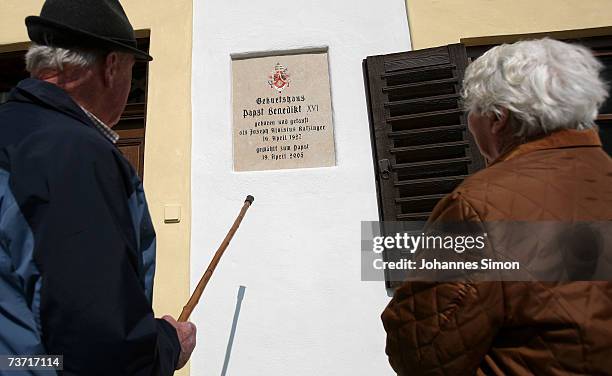 Tourists view the freshly painted facade of Pope Benedict XVI birthplace on March 27, 2007 in Marktl, Germany. The Pope's birthplace is currently...