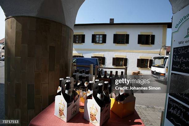 Beer packs decorated with the Pope's portrait are displayed opposite to the house where Pope Benedict XVI was born on March 27, 2007 in Marktl,...