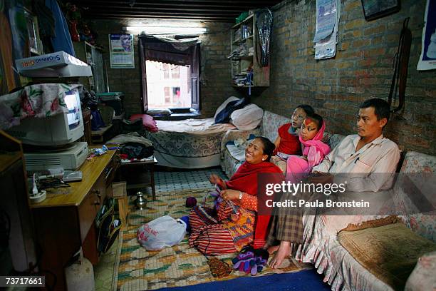 Kumari Devi Sajani Shakya watches TV with her family, mother- Rukmani, father-Nhuchha and sister-Salina at their home on March 25, 2007 in Bhaktapur,...