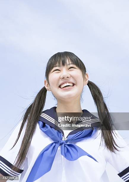 smiling teenage girl - 二つに結んだ髪 ストックフォトと画像