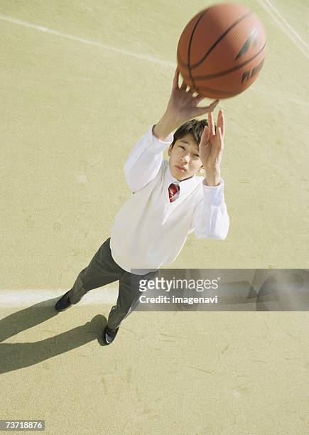 schoolboy playing basketball - basketball uniform stock-fotos und bilder