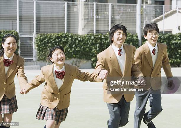 group of students running in athletic field - 12 year old in skirt stock pictures, royalty-free photos & images