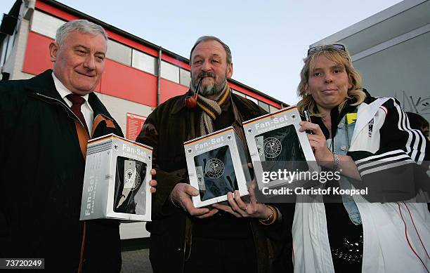 Volunteer hands out gifts from the German Football Association before the Under 21 international friendly between Germany and Czech Republic at the...