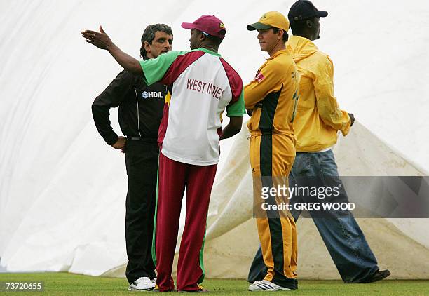 St John's, ANTIGUA AND BARBUDA: Australia's captain Ricky Ponting listens to West Indies captain Brian Lara and umpire Asad Rauf during a rain delay...