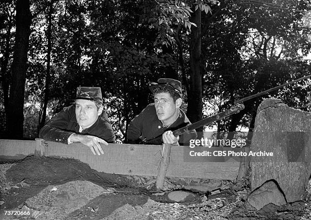 American film and television actors Jack Lord and Gerald Sarracini on the set in character during the production of the episode 'A Day Before Battle'...