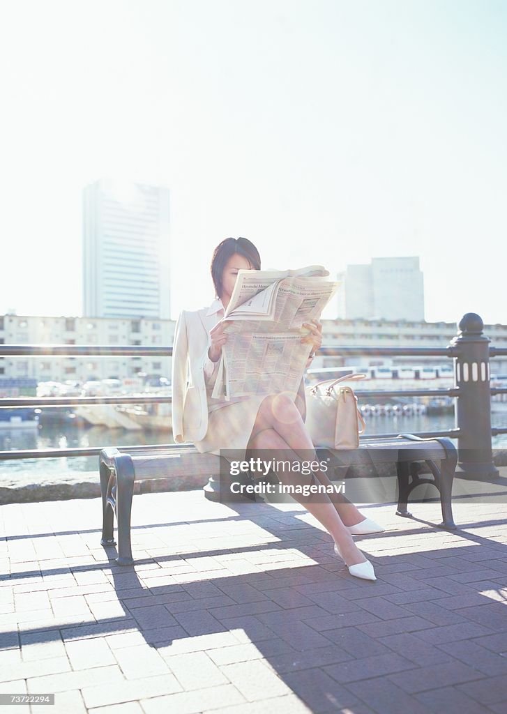 Business woman reading newspaper