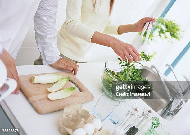 a couple in kitchen - endivie stock-fotos und bilder