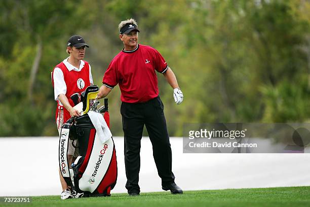 John Cook of the USA chooses his club at the par 5, 11th hole during the second day of the 2007 Tavistock Cup held at the Lake Nona Golf Club on...