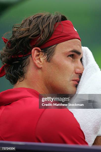 Roger Federer of Switzerland wipes his face during his match against Guillermo Canas of Argentina during day seven at the 2007 Sony Ericsson Open at...