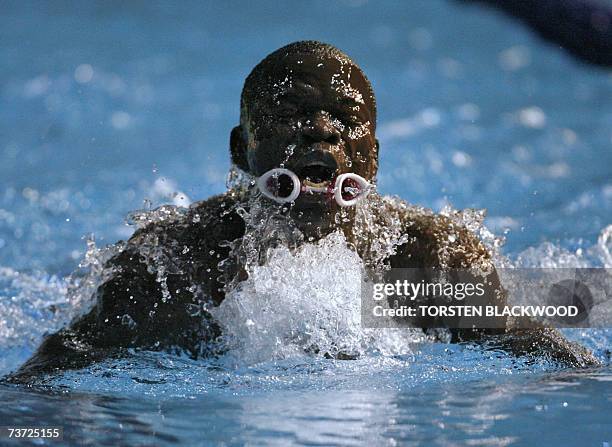 This photo taken 27 March 2007 shows Gibrilla Bamba of Sierra Leone swimming after dislodging his goggles during the men's 50 meter breaststroke...