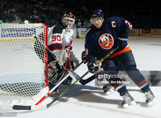 Alexei Yashin of the New York Islanders skates past Martin Brodeur of the New Jersey Devils during their game on March 27, 2007 at Nassau Coliseum in...