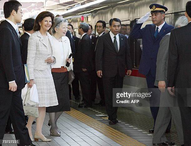 Japanese Empress Michiko and Swedish Queen Silvia walk along the platform at Seibu Railway Shinjuku Station in Tokyo, 28 March 2007, as they leave...