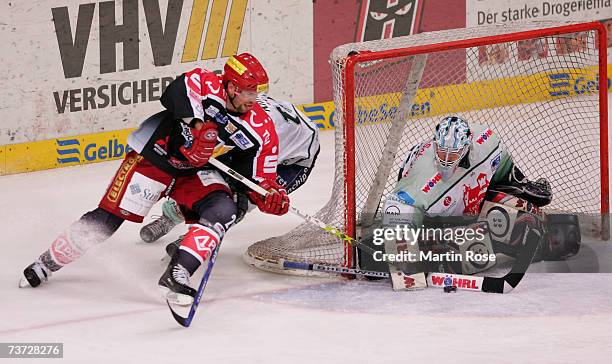 Rene Roethke of Hanover tries to score over Jean Francois Labbe goalkeeper of Nuremberg during the DEL Bundesliga paly off quarter final game between...