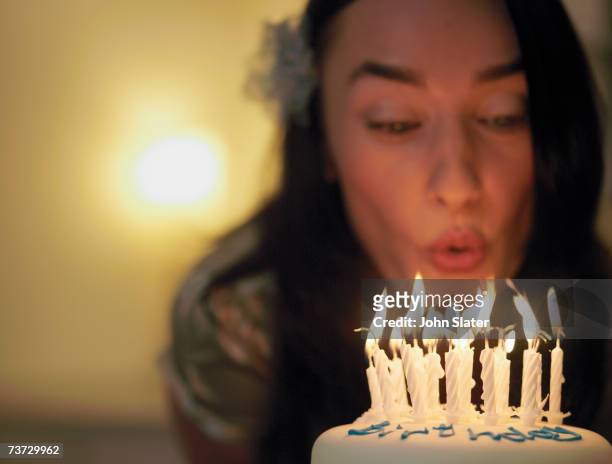 "woman blowing out candles on birthday cake, focus on candles" - woman birthday stock pictures, royalty-free photos & images