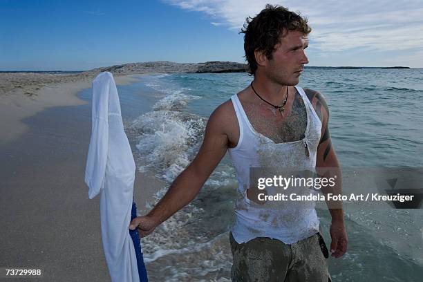 man walking with homemade flag on beach - einsame insel stock-fotos und bilder