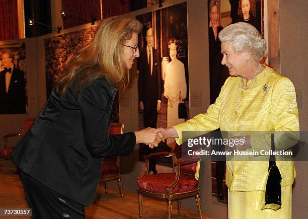 Queen Elizabeth ll greets photographer Annie Leibovitz at a reception for Americans based in Britain at Buckingham Palace on March 27, 2007 in...