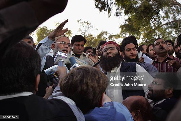 Islamic clerics hold a press conference at the Lal Mosque madrassa where students are holding three women and two policemen hostage in Islamabad,...