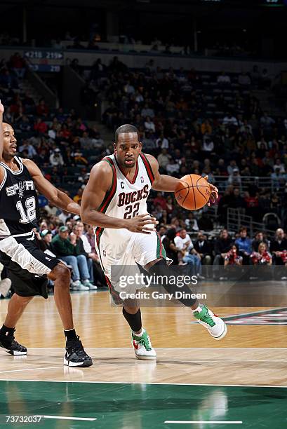 Michael Redd of the Milwaukee Bucks drives to the paint around Bruce Bowen of the San Antonio Spurs at Bradley Center on March 15, 2007 in Milwaukee,...