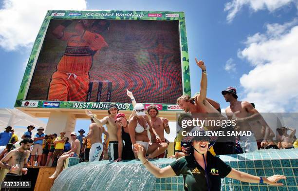 St John's, ANTIGUA AND BARBUDA: Australian cricket fans celebrate their victoy over West Indies on a pool at the end of the ICC World Cup Super Eight...