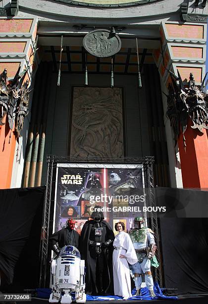 Hollywood, UNITED STATES: Star Wars characters pose in front of the new US forty one cent postage stamps unveiled 28 March 2007 at the Chinese...