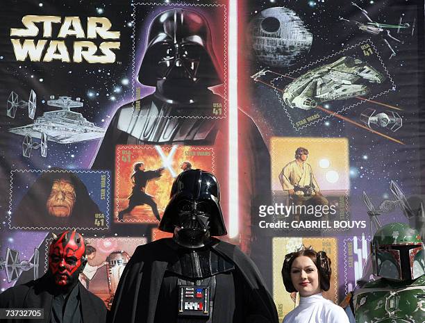 Hollywood, UNITED STATES: Star Wars characters pose in front of the new forty one cent US postage stamps unveiled 28 March 2007 at the Chinese...