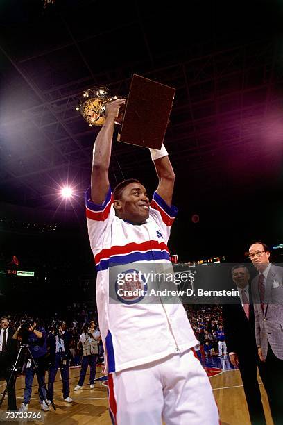 Isiah Thomas of the Detroit Pistons holds the Larry O'Brien Trophy up after the Pistons won the 1989 NBA Championship in Detroit Michigan. NOTE TO...