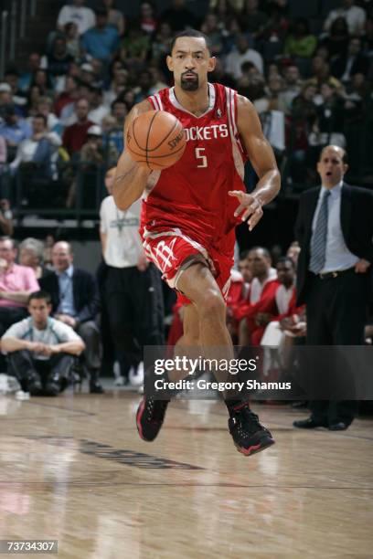 Juwan Howard of the Houston Rockets brings the ball upcourt against the New Orleans/Oklahoma City Hornets during the game at the New Orleans Arena on...