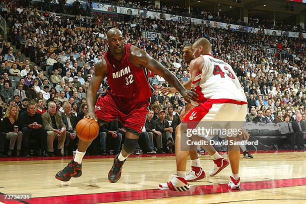 Kris Humphries of the Toronto Raptors guards against Shaquille O'Neal of the Miami Heat on March 28, 2007 at the Air Canada Centre in Toronto,...