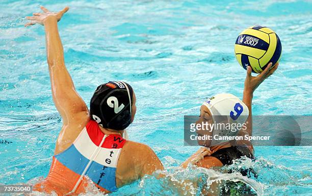 Fernanda Lissoni of Brazil looks to pass over Yasemin Smit of Netherlands in the Women's Final Round 9th-10th place Water Polo match between Brazil...
