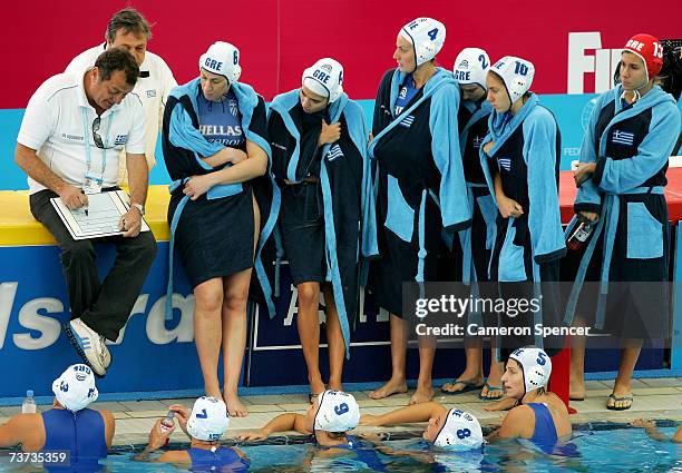 Greece Head Coach Kiriakos Iosifidis speaks to his players during the Women's Final Round Water Polo match between Greece and Italy at the Melbourne...