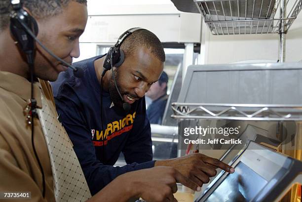 Golden State Warriors' Baron Davis completes an order at the drive-thru window of McDonald's March 28, 2007 in Oakland, California. NOTE TO USER:...