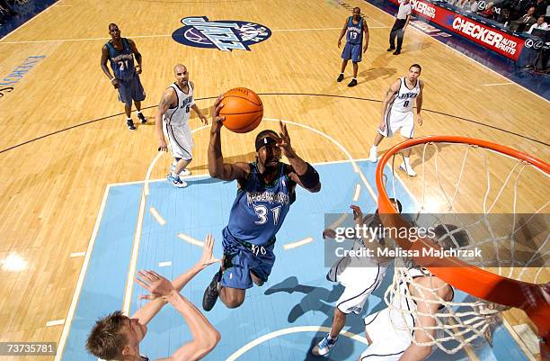 Ricky Davis of the Minnesota Timberwolves shoots over Andrei Kirilenko, Derek Fisher, and Mehmet Okur of the Utah Jazz on March 28, 2007 at the...