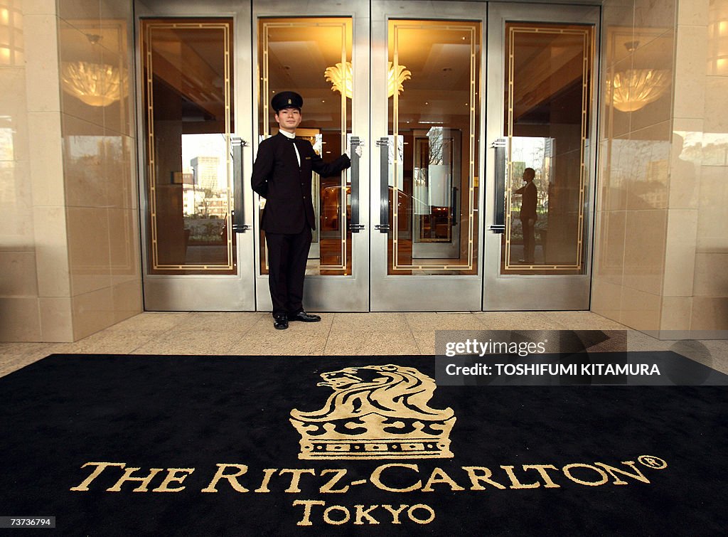 A doorman stands at the main entrance of...