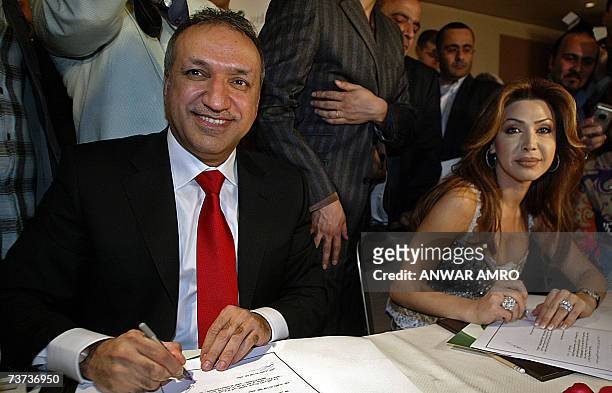 Lebanese singer Nawal al-Zoghbi signs with Salem al-Hinidi, Middle East Manger of Rotana music company, a contract during a a press conference late...