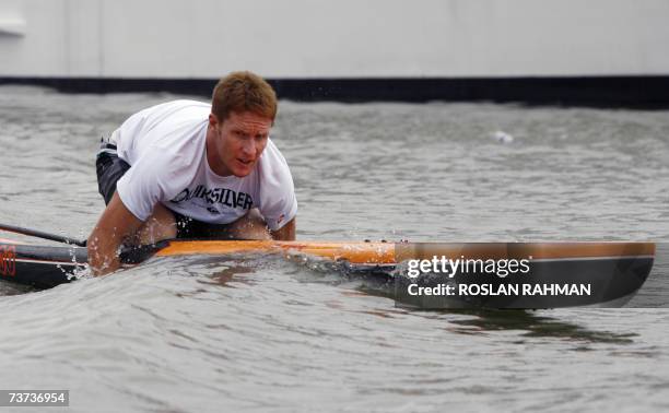 Jackson English an Australian athlete and teacher with United World College of south east asia in Singapore practice hands rowing on a paddle board...