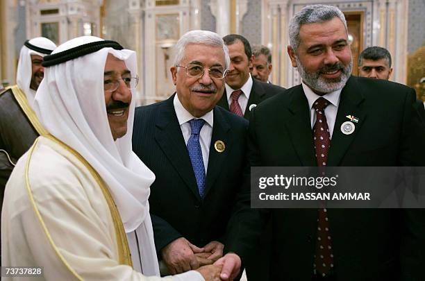 Emir of Kuwait Sheikh Sabah al-Ahmed al-Sabah shakes hands with Palestinian leader Mahmud Abbas and Palestinian prime minister Ismail Haniya after...