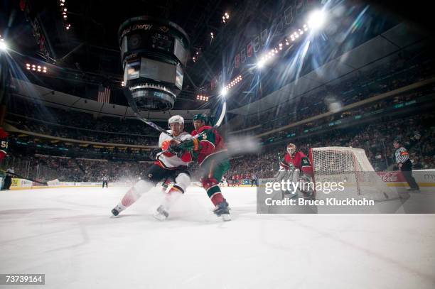 Kim Johnsson of the Minnesota Wild skates against Alex Tanguay of the Calgary Flames during the game at Xcel Energy Center on March 27, 2007 in Saint...