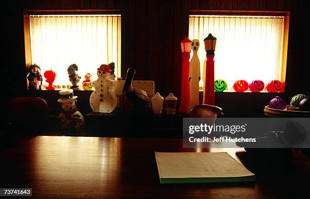 Assorted lawn ornaments and figures sit in the former office of Donald Featherstone, inventor of the plastic pink flamingo, at the Union Products...