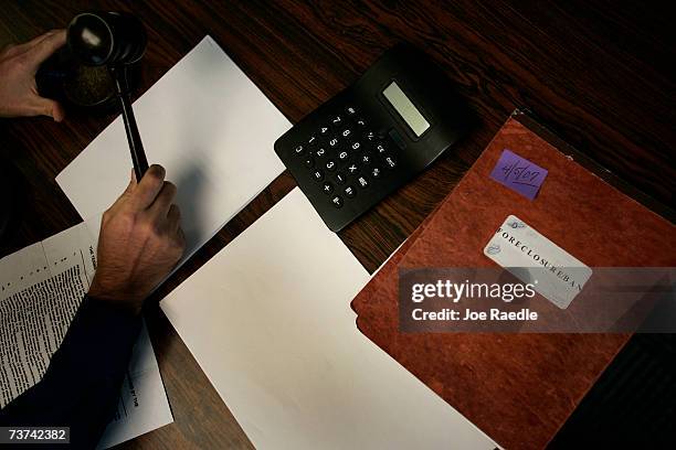 Auctioneer Timothy O'Connor gavels to order a foreclosure auction at a Miami-Dade courtroom March 29, 2007 in Miami, Florida. The twice-a-week...