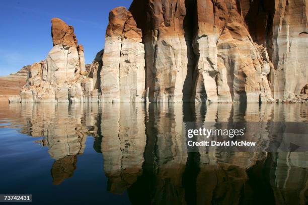 Bleached "bathtub ring", the result of a six-year drought that has dramatically dropped the level of the reservoir, shows on red Navajo sandstone...