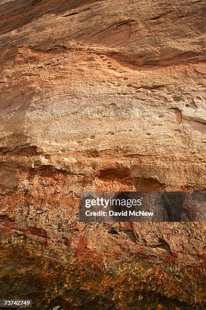 Ancient Moki, or Anasazi people, steps carved into huge steep rocks faces rise from deep under Lake Powell in Fiftymile Creek Canyon and up through...