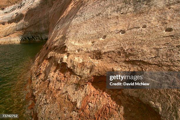 Ancient Moki, or Anasazi people, steps carved into huge steep rocks faces rise from deep under Lake Powell in Fiftymile Creek Canyon and up through...