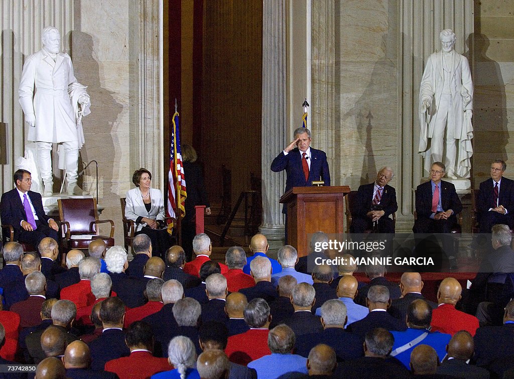 US President George W. Bush salutes the...