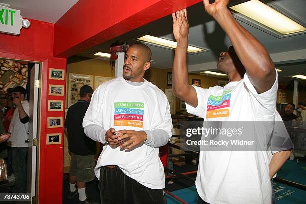Corliss Williamson and Coach T.R. Dunn take a break in action during Cesar Chavez Day of Service at the Washington Neighborhood Center on March 28,...
