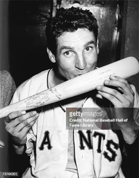 Bobby Thomson of the New York baseball Giants kisses the bat with which he hit the homerun called the "shot heard 'round the world" which gave the...
