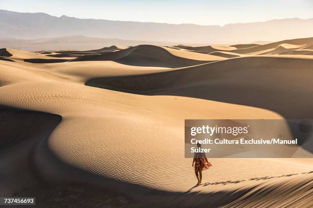 woman walking alone, mesquite flat sand dunes, death valley national park, furnace creek, california, usa - mesquite flat dunes stock pictures, royalty-free photos & images