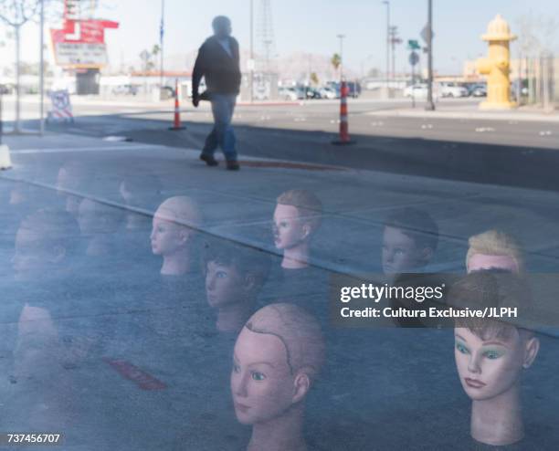 mannequin heads reflected in window with man walking past - las vegas crazy bildbanksfoton och bilder